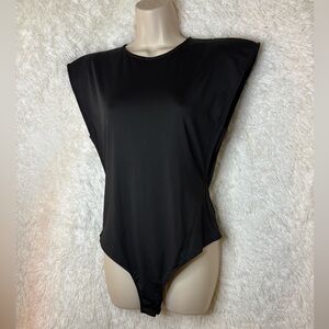 Sleek 80s inspired minimalist sleeveless bodysuit with shoulder pads